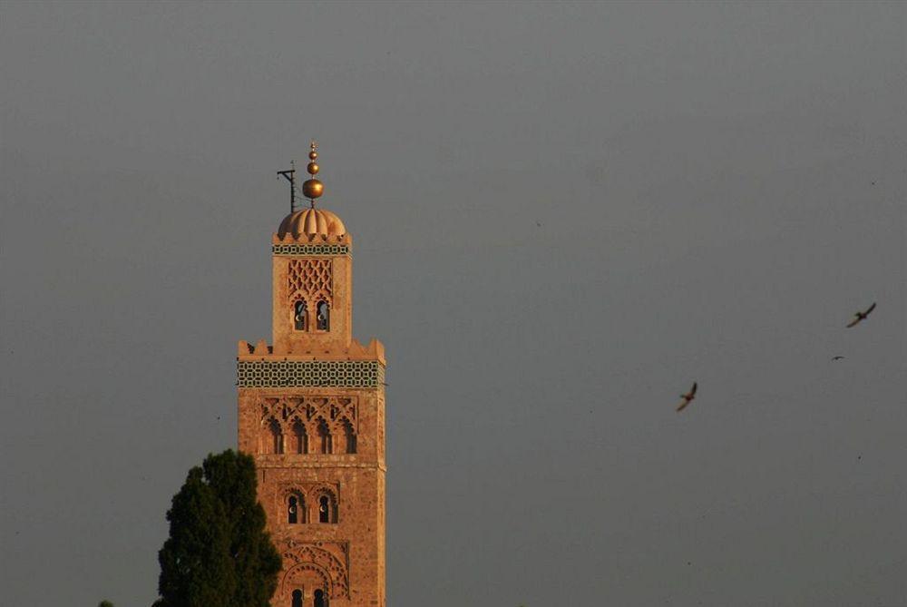 Riad Kniza Marrakesh Exterior photo The minaret of the Kutubiyya Mosque in Marrakesh